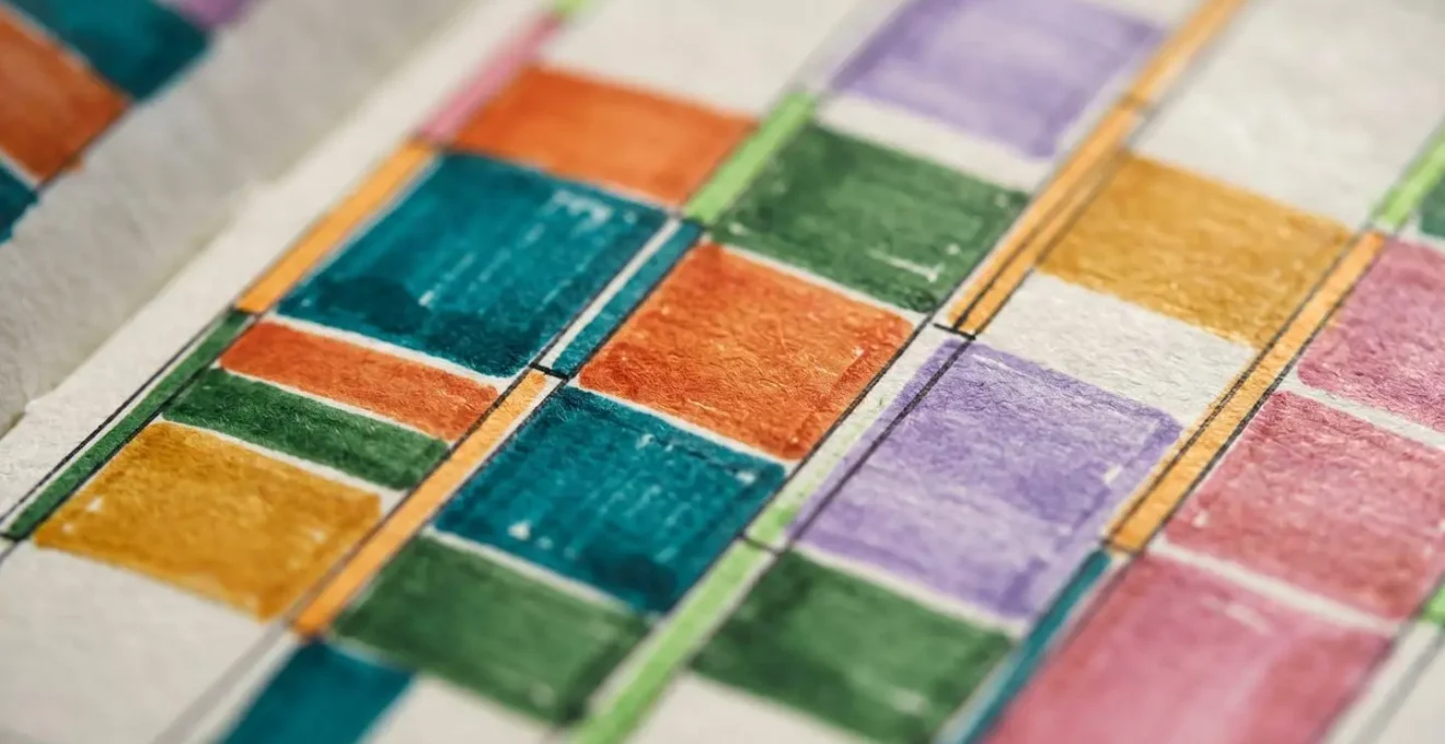 Gros plan sur un agenda papier avec des blocs de temps colorés organisés par type d'activité cognitive